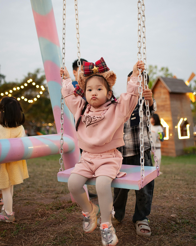 Children on a playground swing near Brookswood Park